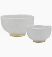 The organic-shaped Speckle Milk footed noodle bowl offers a high gloss glaze with a dimpled, tactile feel