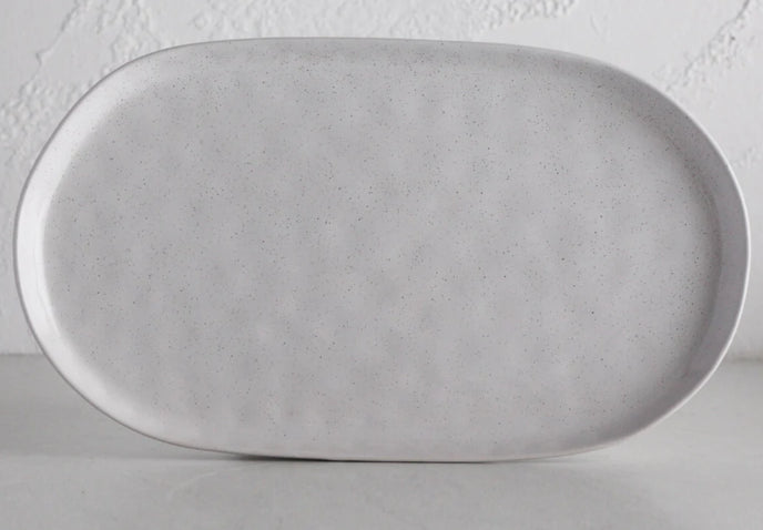 Organic in shape with a dimpled, tactile finish, Ecology's Speckle Oval Serving Serving Platter in Milk has an earthy, wholesome feel.
