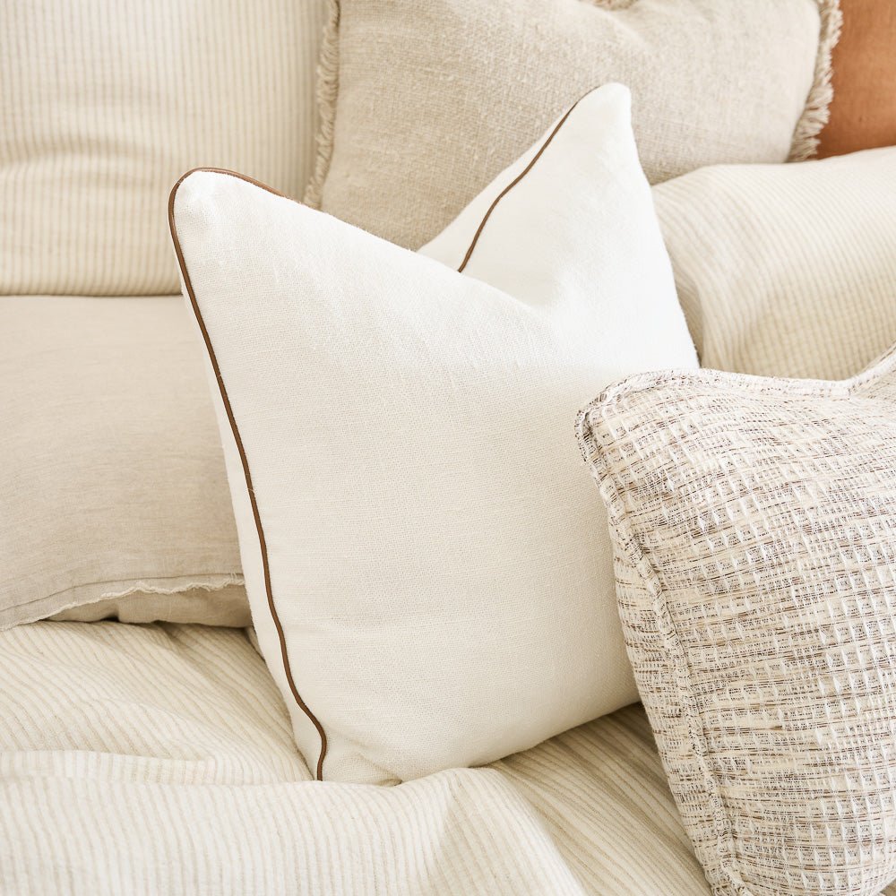 With its refined simplicity, the Muse linen cushion is crafted from a luxe, heavy weight linen with a refined leather piping.